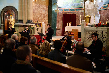 Musicians perform in a beautiful church setting during a concert for the community