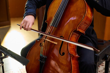 Cellist performing a soulful piece in a tranquil church setting