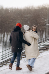 Portrait of a child in the arms of parents in winter