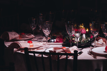 Beautiful table decoration for luxury  event in pink and gold, cutlery and tableware, banquet hall arrangement decor, celebration in restaurant with flowers, candles on a wedding reception party