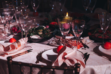 Beautiful table decoration for luxury  event in pink and gold, cutlery and tableware, banquet hall arrangement decor, celebration in restaurant with flowers, candles on a wedding reception party