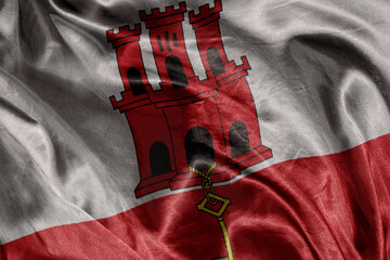 shine waving colourful realistic national flag of gibraltar . macro shot