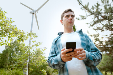 Electrician holding a phone, ensuring reliable power supply and safe operation of electrical...