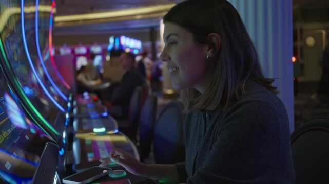 Woman enjoying slot machines in a vibrant las vegas casino setting with colorful lights and lively atmosphere.