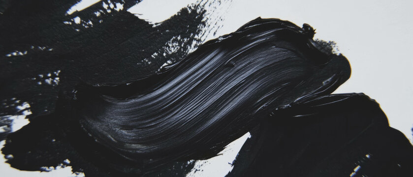 Black ink texture created with a dropper on white paper showcasing precision and artistry