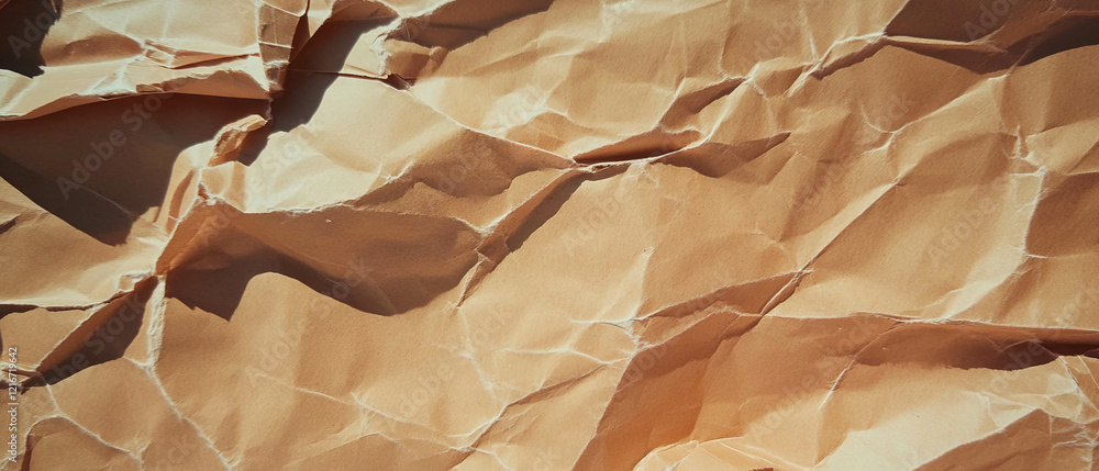 Poster textured kraft paper with irregular edges and visible tears creates a distressed aesthetic