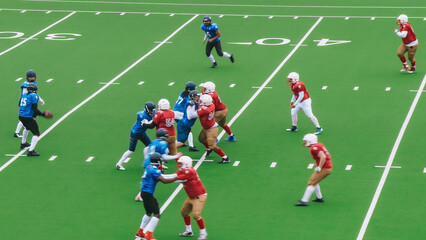 Diverse Male Athletes in Red and Blue Jerseys Compete in an American Football Game. Motivated...