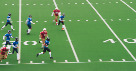 American Football Match with Diverse Male Athletes in Red and Blue Jerseys Run in a Field, Battle for the Ball. Athletic Player Runs with the Ball