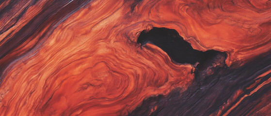 Rich mahogany wood texture featuring intricate red-brown grain patterns and a deep contrast