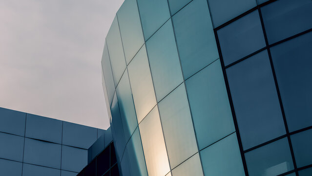facade of an office building with blue walls and mirrored windows