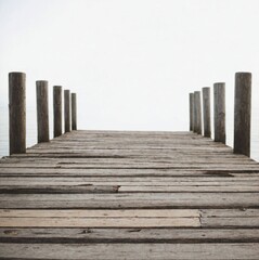 Fototapeta premium A Calm and Serene Wooden Pier Standing Over Still Water in a Mystically Misty Atmosphere