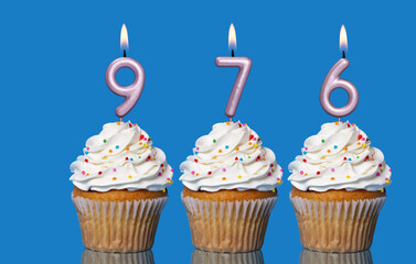 Birthday Cupcakes With Candles Lit Forming The Number 976
