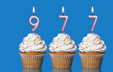 Birthday Cupcakes With Candles Lit Forming The Number 977