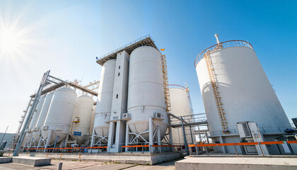 Obraz premium Fuel storage tanks under bright sunlight, energy reserves