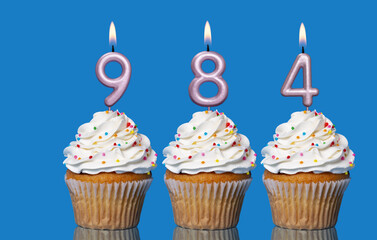 Birthday Cupcakes With Candles Lit Forming The Number 984