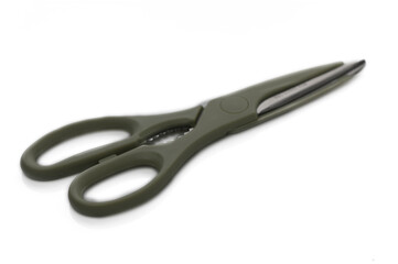 Elegant scissors with a sleek design resting on a white surface in soft natural light