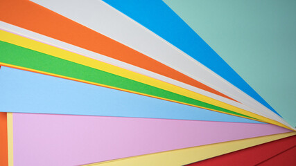Colorful spectrum of paper sheets arranged creatively on a surface