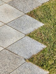 Diamond- shaped pavement block and grass in zig zag pattern