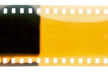 Dusty and grungy 35mm film texture or surface. Perforated scratched camera film isolated on white...