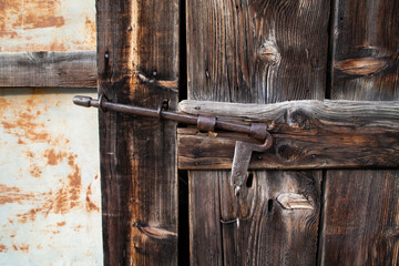 Antique latch on old barn door in Switzerland