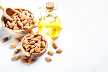 Almond nuts and almond oil at white background. Healthy fat, omega 3 sources.