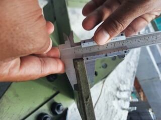 Accurate measurement of a steel frame using a caliper for construction purposes