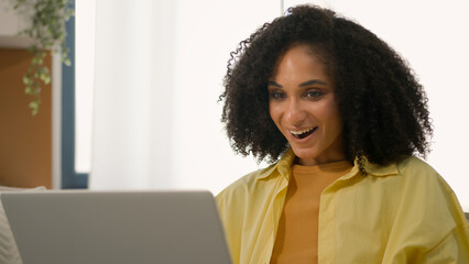 African American shocked ethnic woman freelancer businesswoman using computer happy emotion wonder...