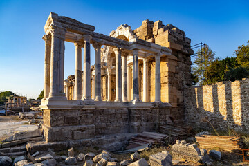 View of ruins of the columns of the Nymphaeum Fountain in the ancient Side at sunset.  Manavgat, Antalya, Turkey. 