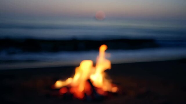 Serene bonfire on seashore during sunset with gentle ocean waves