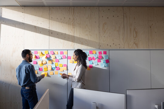 Coworkers brainstorming ideas for a business startup in an office