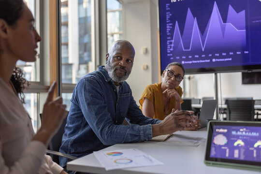 Mature African American businessman listening in a team meeting