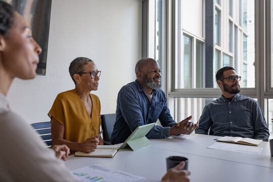 Successful mature businessman smiling in a business meeting at company growth