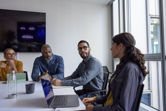 Hispanic businessman listening to a colleague in an office meeting