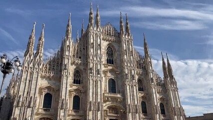 The Duomo of Milan Cathedral facade on sunny day. Italian landmark in Town Square. Catholic religion, travel destination concepts