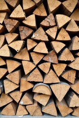 A Stack of Triangularly Shaped Wood Logs, Ready for the Fireplace or Wood Stove, Showing Beautiful Natural Wood Grain and Texture