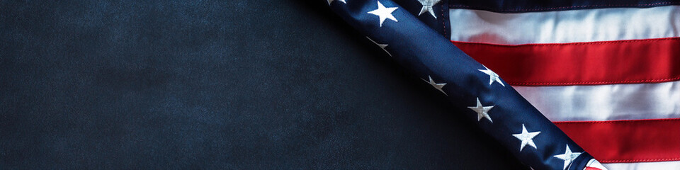 Fototapeta premium American flag draped on a dark surface representing patriotism
