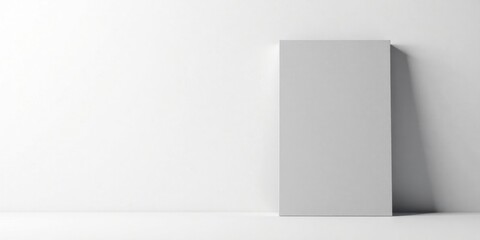 A vertical canvas stands against a minimalist white wall, creating a clean and simple background ideal for design projects and presentations.