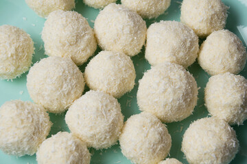 Delicious homemade candies with almonds and coconut flakes. Candies close-up macro on a light background
