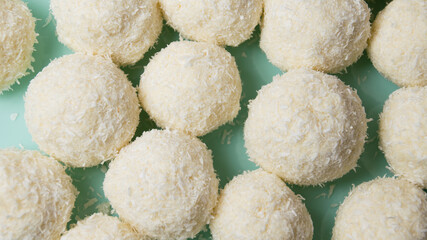 Delicious homemade candies with almonds and coconut flakes. Candies close-up macro on a light background