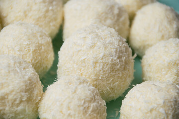 Delicious homemade candies with almonds and coconut flakes. Candies close-up macro on a light background