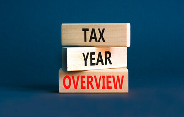 Tax year overview symbol. Concept words Tax year overview on beautiful wooden blocks. Beautiful grey table grey background. Business tax year overview concept. Copy space.