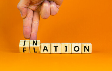 Flation or inflation symbol. Concept words Inflation or Flation on beautiful wooden blocks. Beautiful orange table orange background. Businessman hand. Business flation inflation concept. Copy space