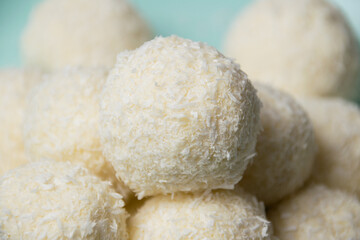 Delicious homemade candies with almonds and coconut flakes. Candies close-up macro on a light background