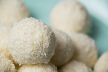 Delicious homemade candies with almonds and coconut flakes. Candies close-up macro on a light background