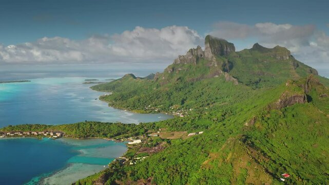 Capturing breathtaking aerial views of Bora Bora, featuring iconic mount Otemanu, lush green slopes, and crystal-clear turquoise lagoon waters