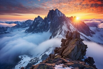 Breathtaking sunset over snowy mountain peaks rising above a sea of clouds, creating a stunning alpine landscape