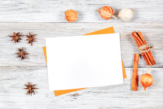 Blank white card mockup with dried anise stars and cinnamon sticks