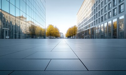 Fototapeta premium A square paved with stone slabs and a leisure park, with high-rise buildings in the city in the distance