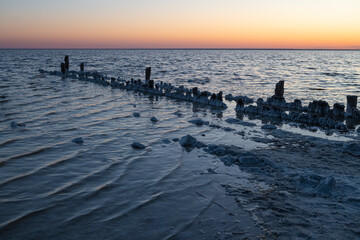 Obraz premium Evening at the old pier. Salt lake of Elton. Volgograd region, Russia