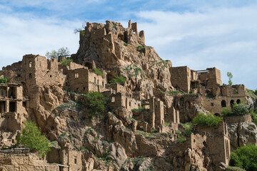 Fototapeta premium View of the ruins of the abandoned mountain village of Gamsutl on a cloudy May morning. Dagestan. Russian Federation
